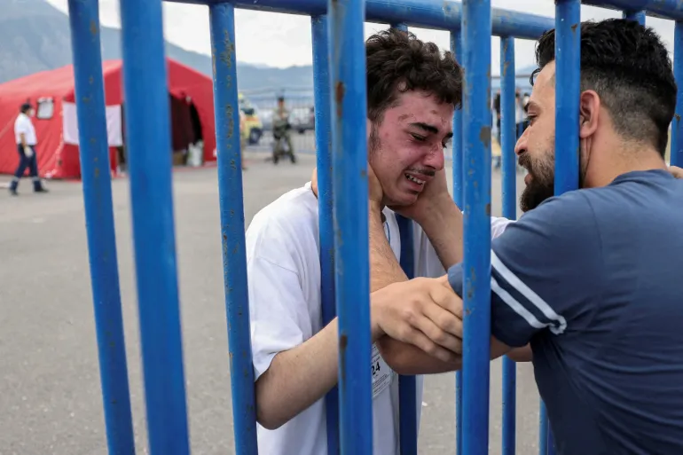 https://dazzlingdawn.com/wp-content/uploads/2023/06/A-Syrian-survivor-cries-as-he-reunites-with-his-brother-at-the-port-of-Kalamata.webp