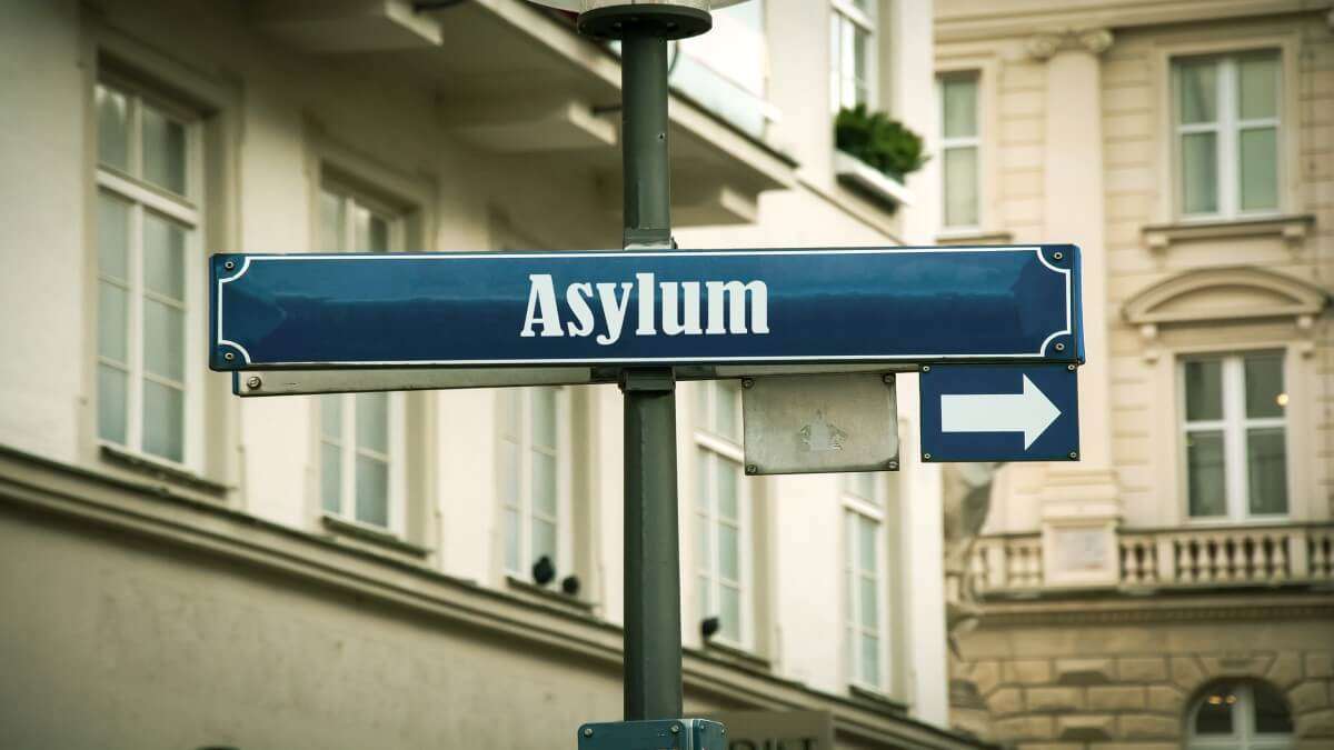 https://dazzlingdawn.com/wp-content/uploads/2023/10/asylum-sign.jpg