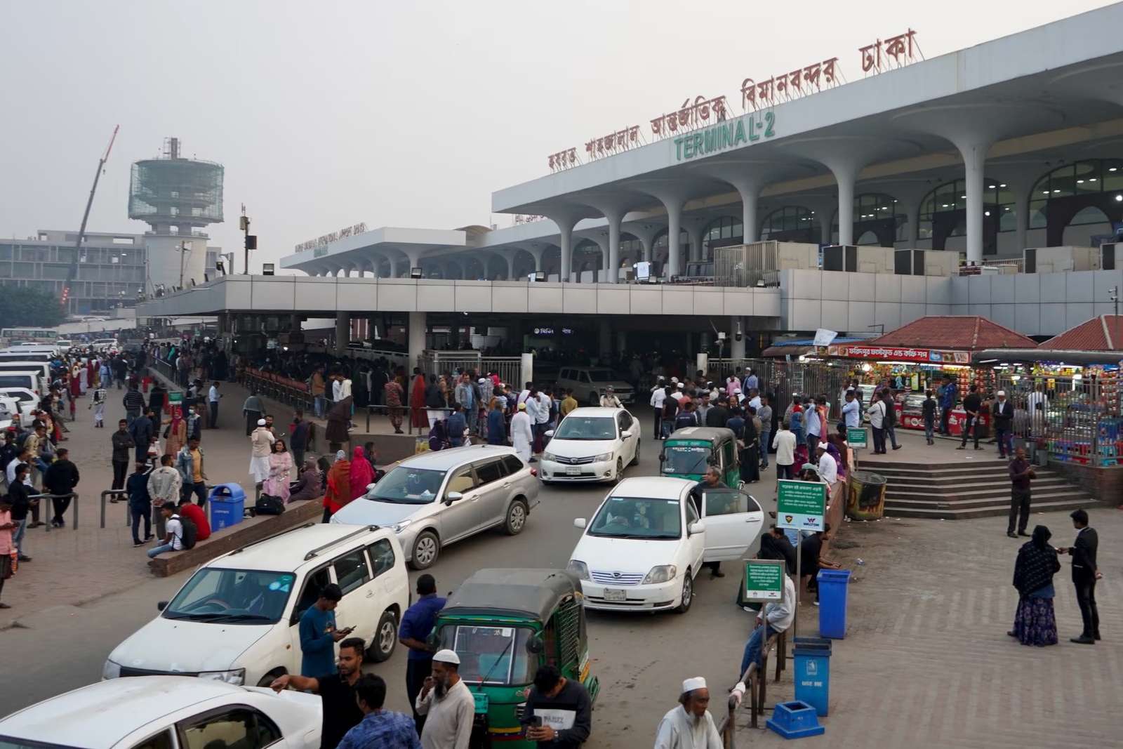 The scene at Dhaka’s international airport, where more and more deported migrants are now found among the business travellers and reunited families