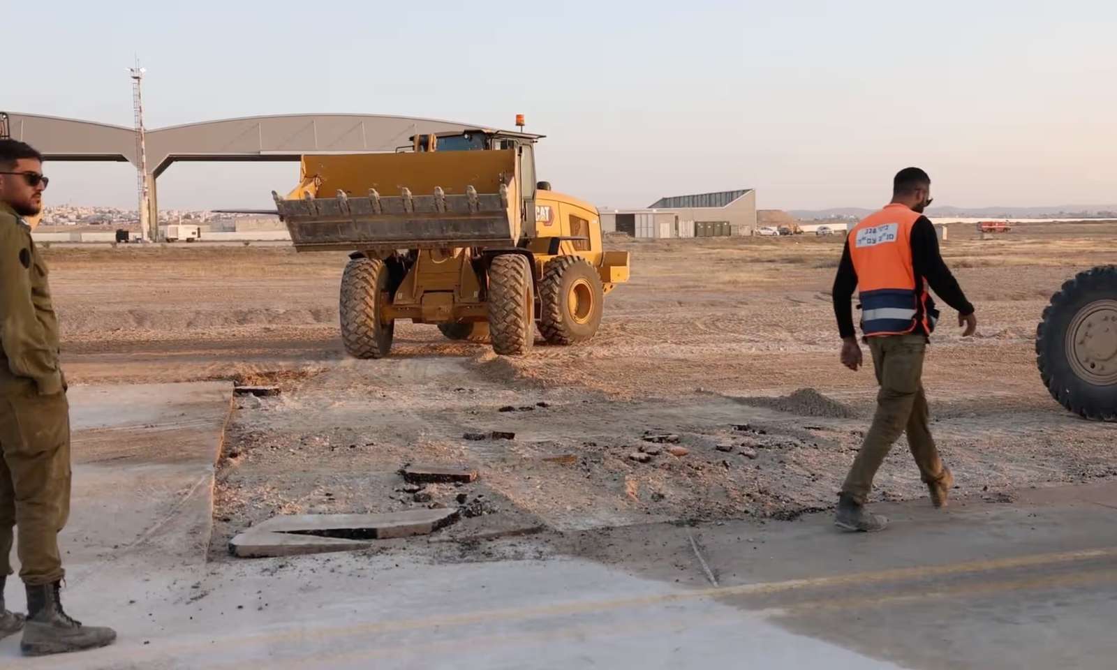 https://dazzlingdawn.com/wp-content/uploads/2024/04/Damaged-area-at-a-location-given-by-the-IDF-as-Nevatim-airbase-scaled.jpg